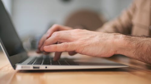 Man Typing on His Laptop
