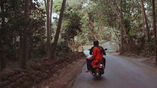 Back View of a Couple Riding a Motorcycle