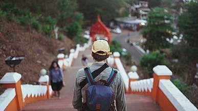 a man with a backpack walks down stairs