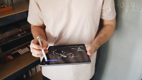 A Man Making A Design Using An Ipad