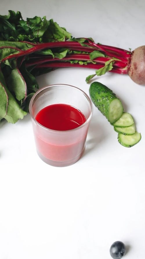 Berries Rolling Around the Cup of Fruit Juice