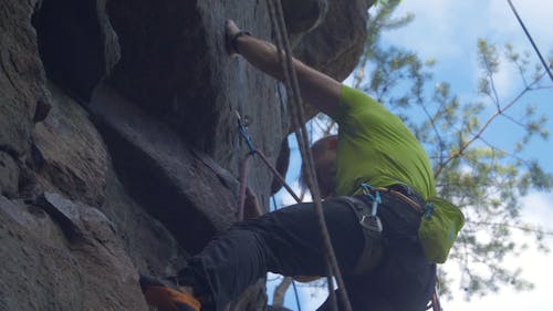 Man Climbing A Rocky Mountain 