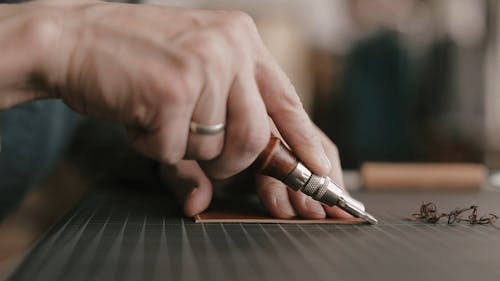 A Person Trimming the Leather