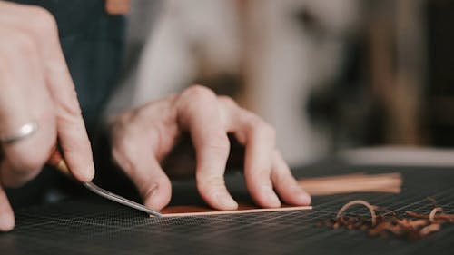 A Person Trimming the Leather