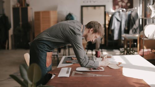 A Man Tracing a Template onto the Leather