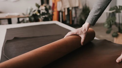 A Leather Worker Rolling Out The Leather