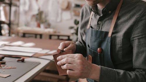 Man Polishing the Edge of the Leather