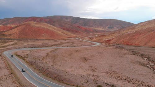 Drone Footage of a Vehicle Driving on a Curvy Road