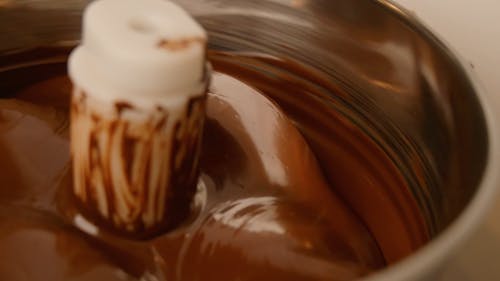 A Close-Up Video of a Chocolate Mixing on a Machine