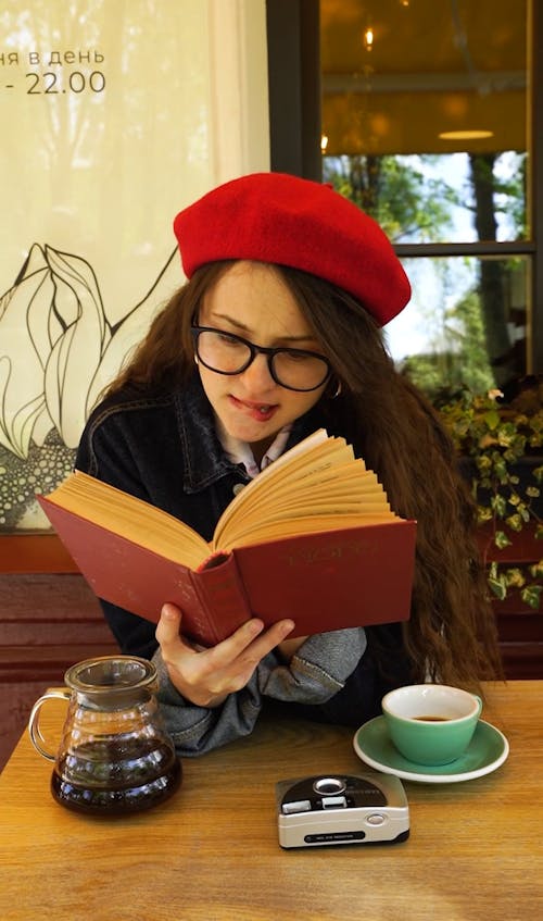 A Woman Reading a Book in a Coffee Shop