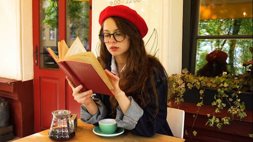 Woman Reading a Book at the Coffee Shop
