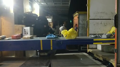 Packages On the Conveyor Going Inside The Truck