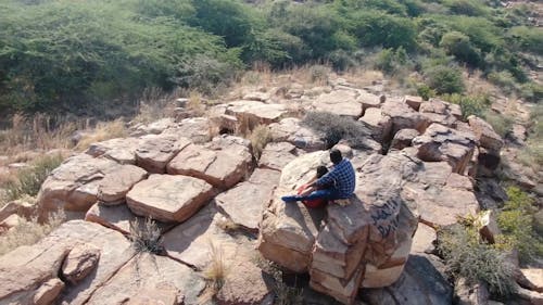 Couple Sitting on Boulders