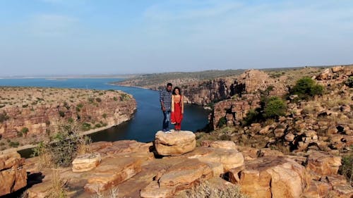 Couple Standing on Rock Cliff