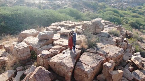 Couple Standing on the Rock Cliff