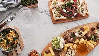 person putting healthy salad on the table