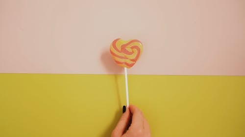 Rolling In Fingers A Heart Shaped Lollipop