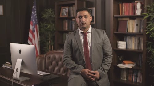 A Businessman Posing on a Table