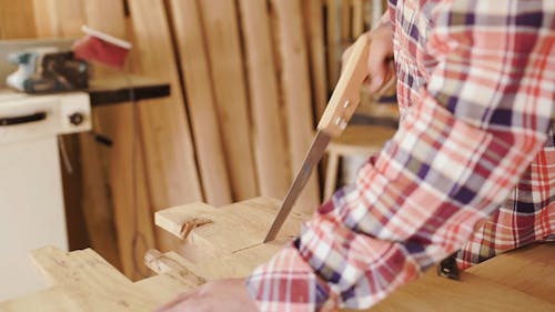 Man Sawing Wood Manually