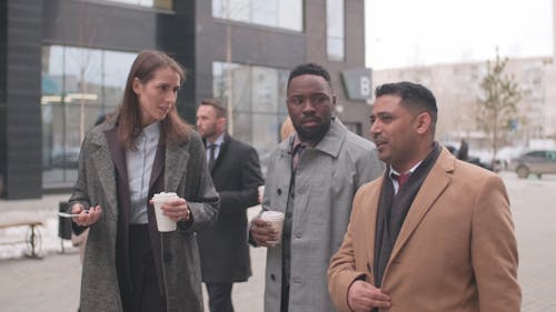 A Group Of Business People Walking Outside
