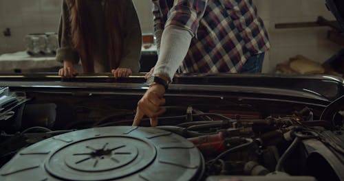 A Grandfather  Teaching Her Grand Daughters About Car Engines