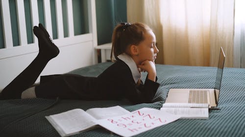 A Young Girl Having On Line Classes While At Home