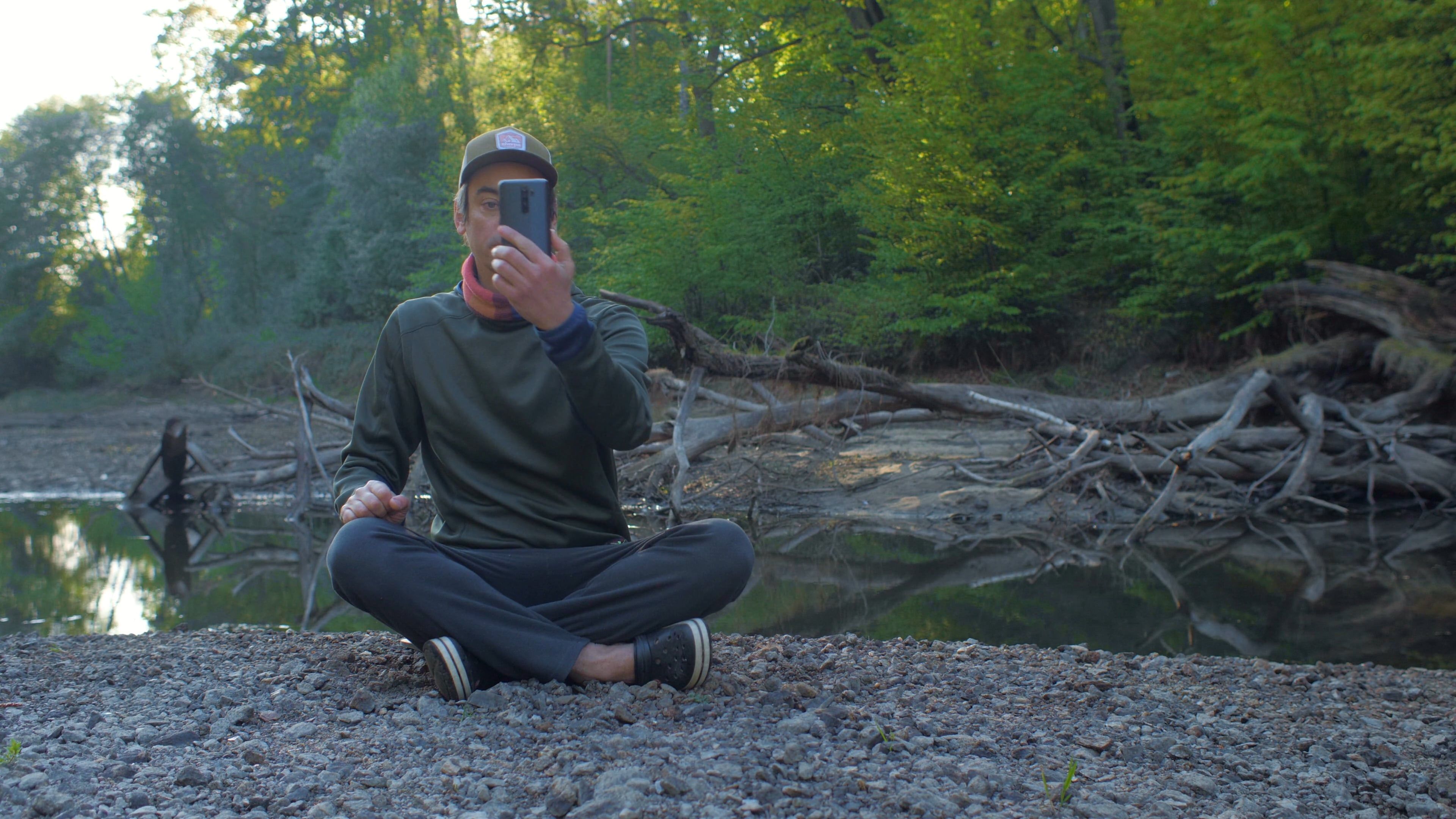 Man Sitting On Rocks Looking For Signal Free Stock Video Footage ...