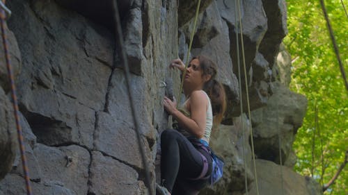 A Woman Climbing A Mountain Rock