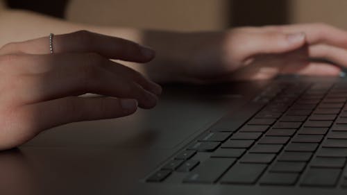 A Person Browsing Using A Laptop