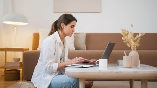 A Woman Having Coffee While Working At Home