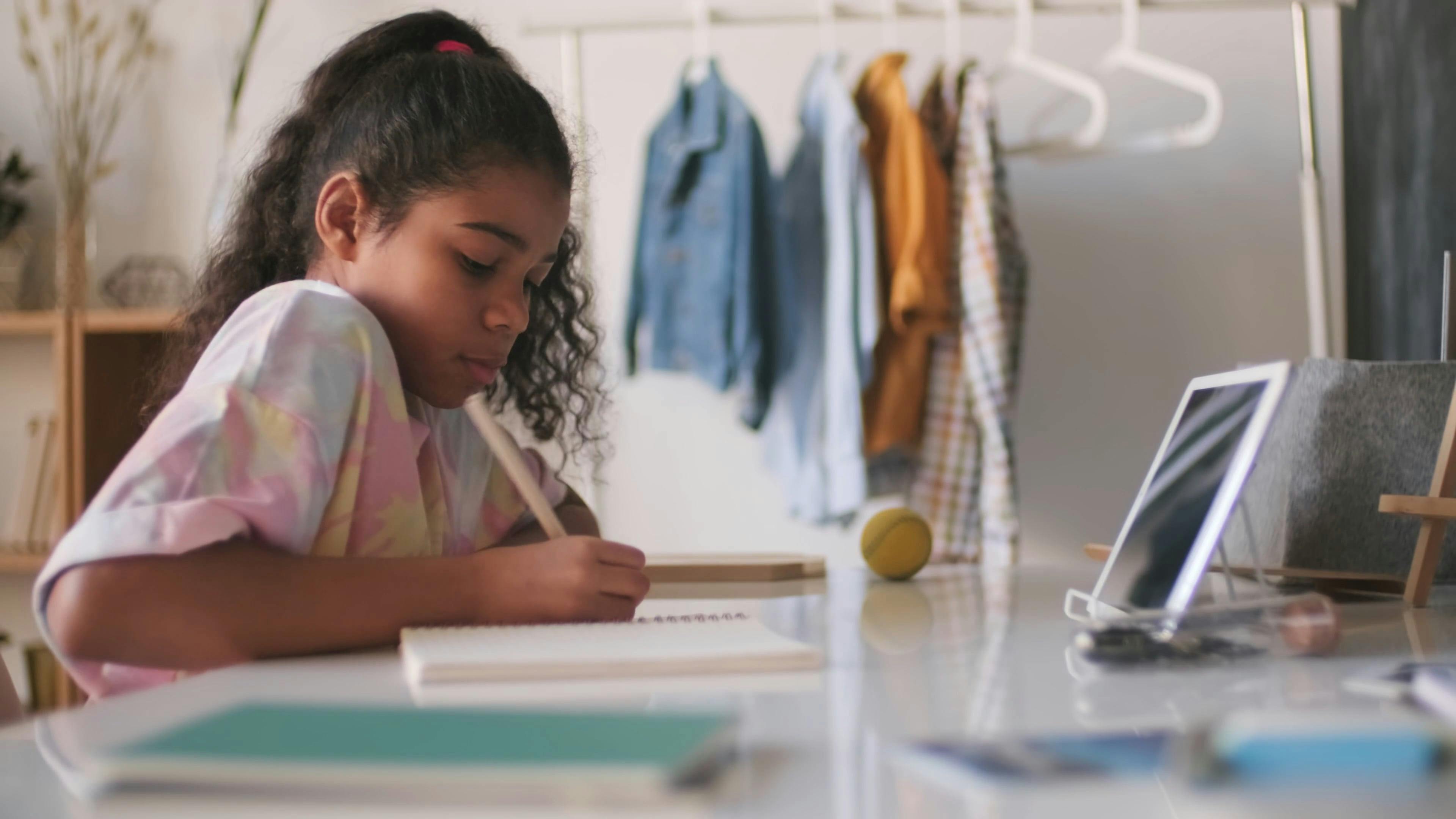 Girl Writing on Her Notebook · Free Stock Video