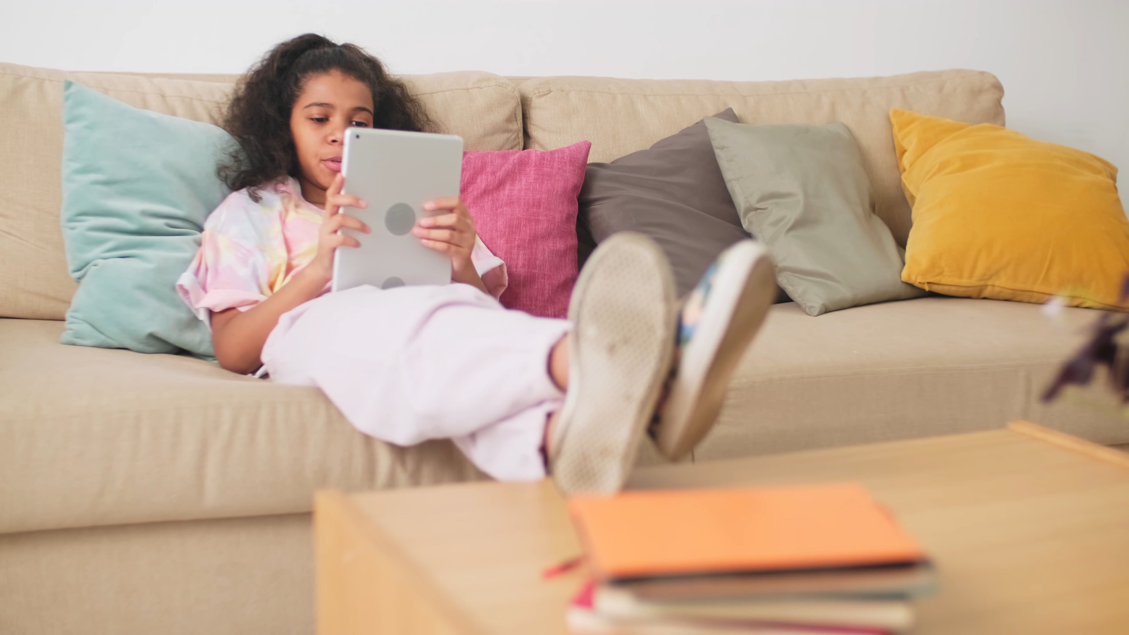 A Girl Using Digital Tablet while Sitting on the Couch · Free Stock Video