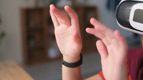 A Youngster Wearing The Headset Of A Virtual Reality Game Console