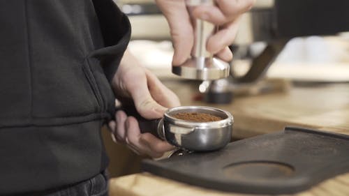 Barista Holding a Coffee Tamper