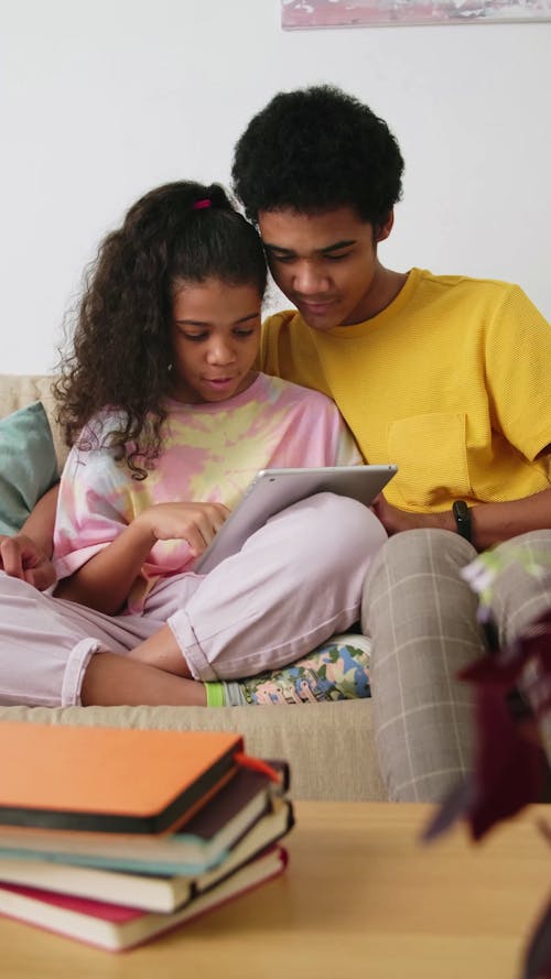 Brother and Sister Sharing Tablet