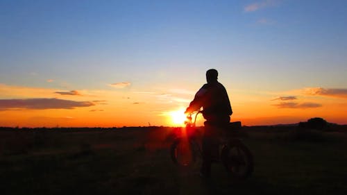 Silhouette Of Man Watching Sunset