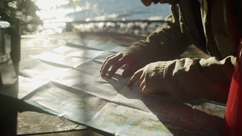 A Man Looking At A Paper Printed Map