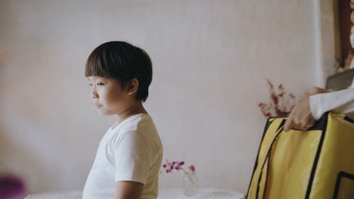 Mother Helping His Son Wearing His Backpack