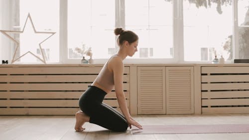 Woman Rolling Her Yoga Mat