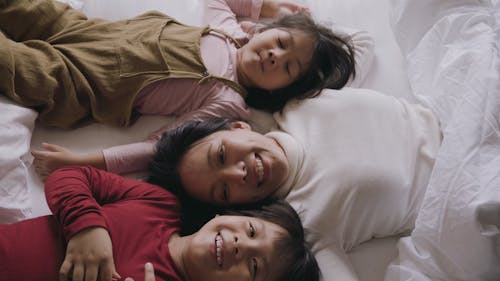 Family Lying Down on the Bed