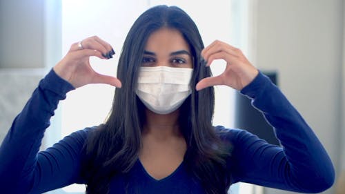 Woman Wearing Facemask Doing Heart Shape in her Hands