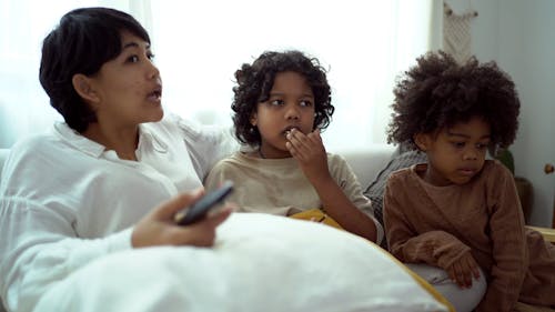 A Mother Talking to Her Kids while Sitting on the Couch