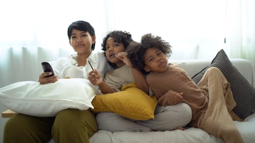 A Mother Talking to Her Children while Sitting on the Couch