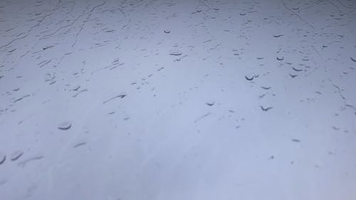 Raindrops on a Glass Panel