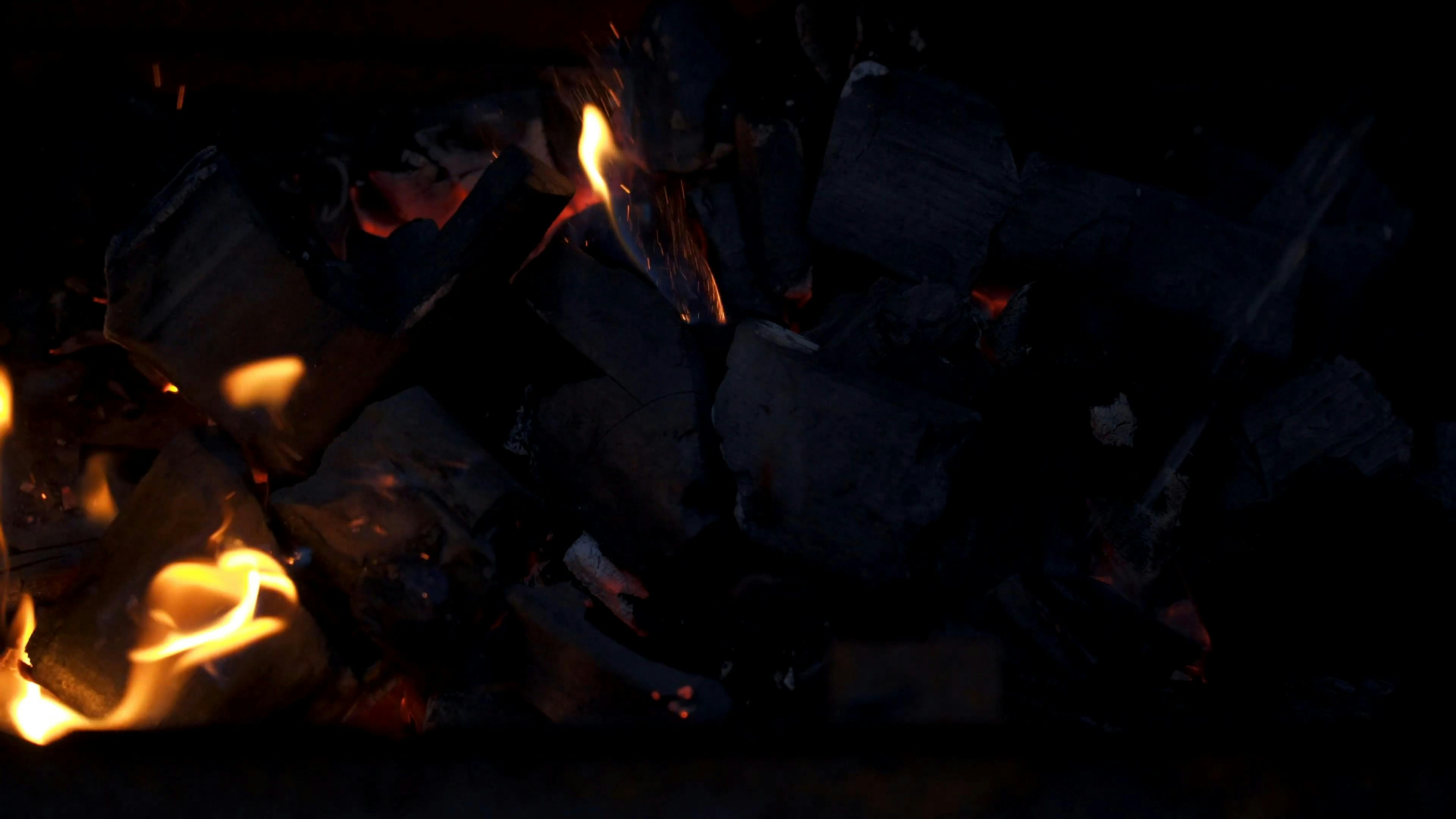 Spraying Lighter Fluid on Burning Coals · Free Stock Video