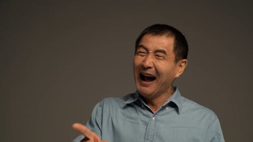 A Man Laughing and Pointing His Finger