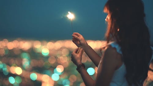 A Woman Holding A Lighted Sparklers