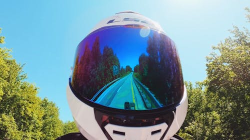 Man Wearing A Helmet While Traveling On A Motorbike