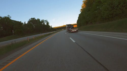 A Vehicle On The Road On A Bright Day