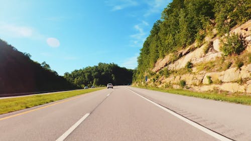 Timelapse Of A Vehicle On Highway Traveling On A Bright Day 